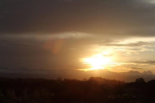 a sunset with a rainbow in the sky at Hotel Chicala salgar in Puerto Salgar