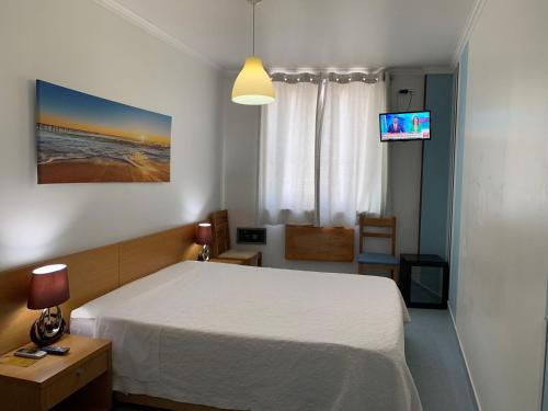 Postel nebo postele na pokoji v ubytování WEAA Hotel