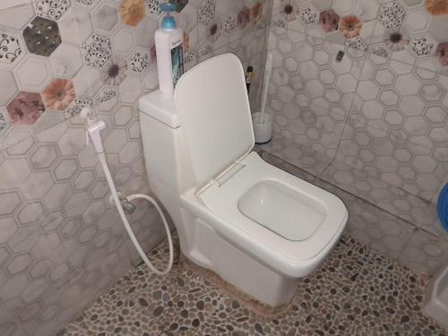 a bathroom with a white toilet in a room at Happy Homes in Mombasa