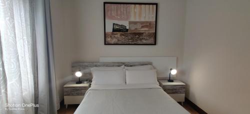 a bedroom with a bed and two night stands at Gasteiz Etxea Il in Vitoria-Gasteiz