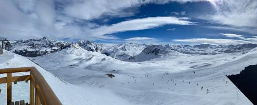 a group of people skiing down a snow covered mountain at Studio Tignes Val Claret in Tignes