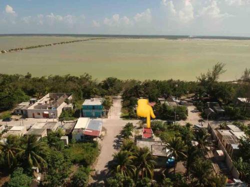 an aerial view of a resort with a large rubber duck statue at Casita Guayaba in El Cuyo