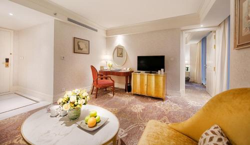 a living room with a couch and a table at Apricot Hotel in Hanoi