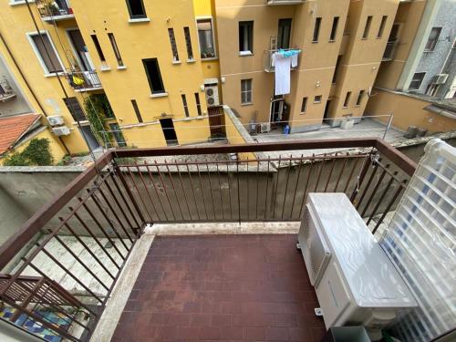 a view of a balcony with a bench and buildings at San Dionigi 11 Studio Apartments in Milan