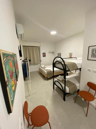 a hospital room with two beds and a table and chairs at San Dionigi 11 Studio Apartments in Milan
