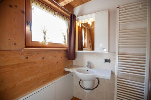 uma casa de banho com um lavatório e uma janela em Casa Giulia em Bormio