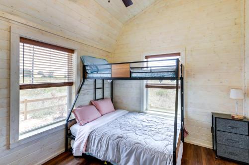 a bunk bed in a room with two windows at Cozy Texas Retreat with Covered Deck and Private Pond! in Lexington