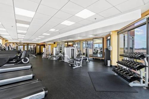 a gym with treadmills and machines in a building at Incredible Apartment with Rooftop in Pentagon City in Arlington