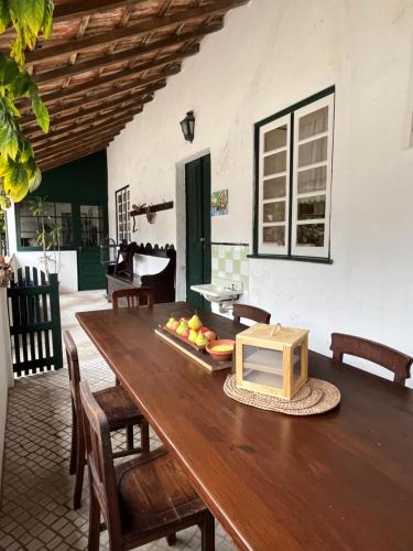 a wooden table with a tray of fruit on it at AVEIRO MAIAS VILLAGE - CASA DO ÁLVARO in Oliveirinha