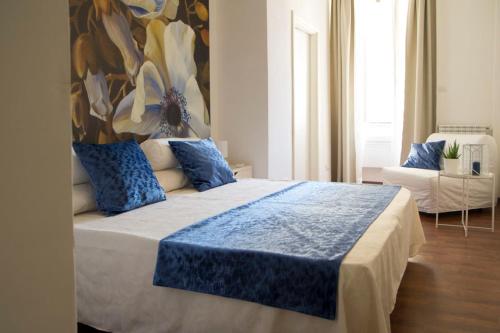 a bedroom with a large bed with a painting on the wall at Domus Crescenzio - Guest House in Rome