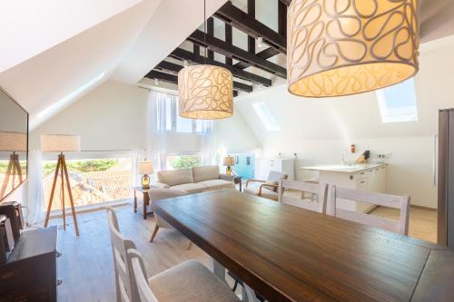 a dining room and living room with a wooden table and chairs at Downtown Dreamstay, Classic 2BR Suites in Willemstad