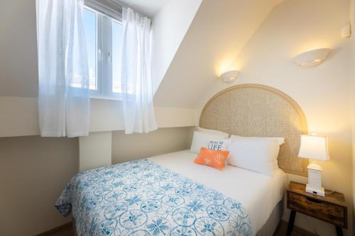a bedroom with a bed and a window at Downtown Dreamstay, Classic 2BR Suites in Willemstad