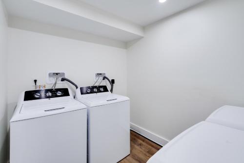a white room with two washing machines in it at The Ledger Residences by Sosuite - Old City in Philadelphia