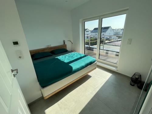 a bedroom with a bed and a large window at your Home near Köln high-end residence 75qm, 15min von Köln Hbf, 20min von Köln Messe in Pulheim