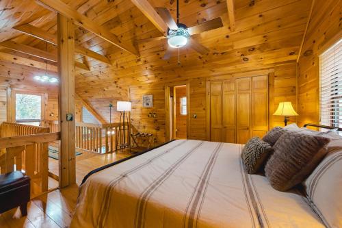 a bedroom with a bed in a log cabin at Sleepy Bear Hideaway in Mineral Bluff