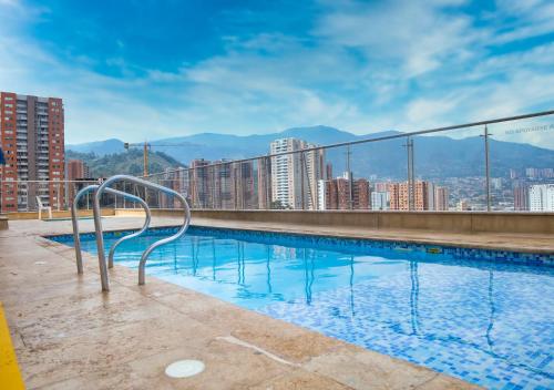a swimming pool on the roof of a building at Century in Sabaneta