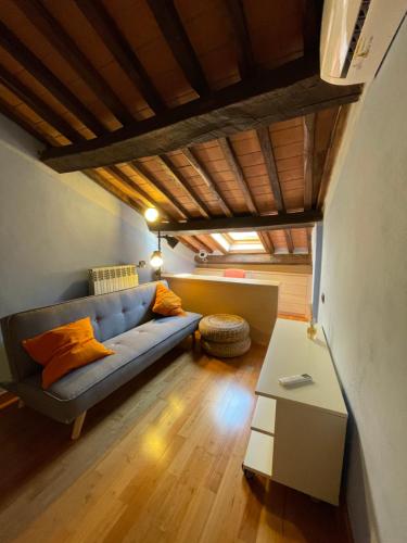 a living room with a blue couch and a table at The Small Sweet House in Montepulciano