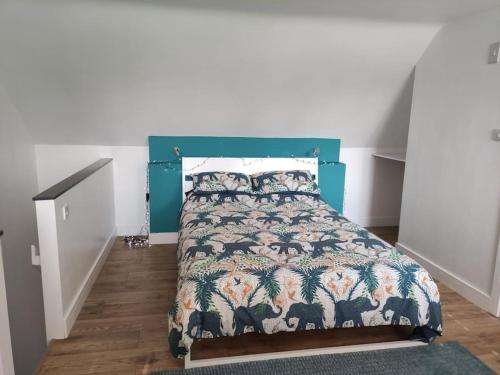 a bedroom with a bed with a green headboard at The Old Bar in Wiltshire - 1 bedroom guesthouse in Chippenham