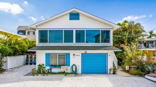 a house with a blue garage at Seahorse Suite home in Bradenton Beach