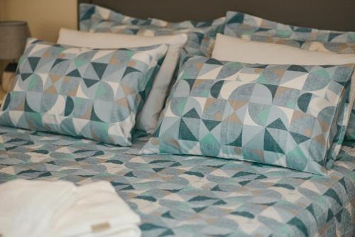 a bed with pillows on top of it at Brisa Mar Apartamento Aconchego in Balneário Camboriú