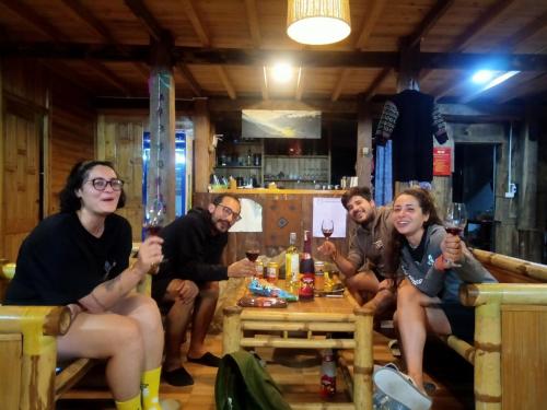 a group of people sitting around a table drinking wine at Tavan Dragon House in Lao Cai
