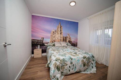 a bedroom with a bed with a painting on the wall at MiraLeón in León