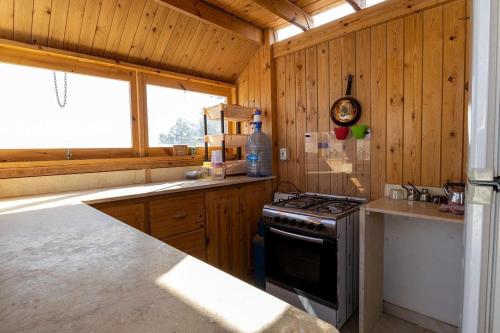 a kitchen with wooden cabinets and a stove top oven at Marine Garden Camp in Dahab