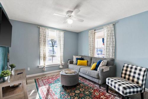 a living room with a couch and a chair at Mins To Dwntwn & Arena Backyard BBQ King Bed in Spokane