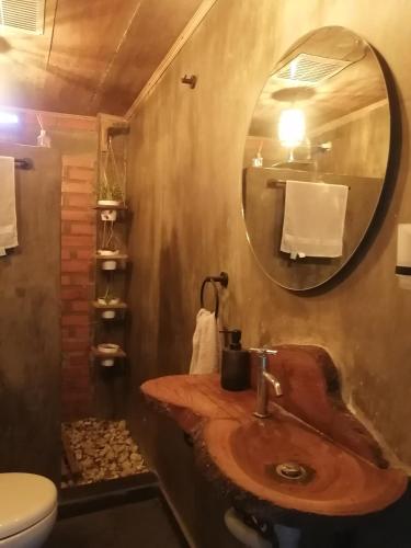 a bathroom with a wooden sink and a mirror at Pistacho in Minca