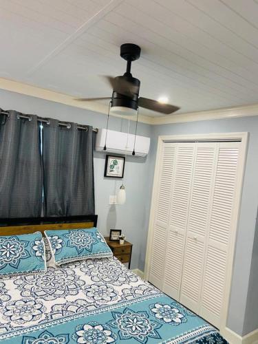 a bedroom with a bed and a ceiling fan at Lovely rental unit with independent entrance apt # 1 in Tampa