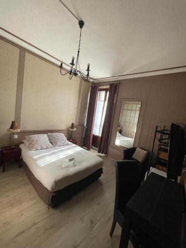 a bedroom with a bed and a chair and a window at Authentic by Balladins, Hôtel Le Carré d'Aix in Aix-les-Bains