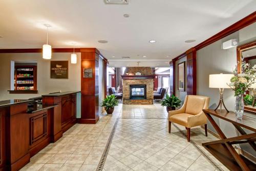 a living room with a fireplace and a table and chairs at Homewood Suites by Hilton Stratford in Stratford