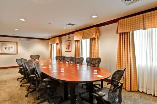 a conference room with a wooden table and chairs at Homewood Suites by Hilton Stratford in Stratford