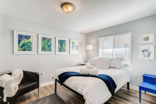 a bedroom with a large bed and a chair at Smart Eclectic ART HOUSE near UC Davis Med Center in Sacramento