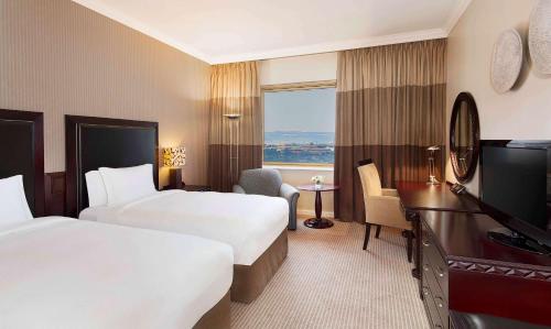 Ένα ή περισσότερα κρεβάτια σε δωμάτιο στο NH Johannesburg Sandton