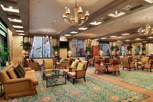 a lobby of a hotel with chairs and tables at Madinah Hilton Hotel in Al Madinah