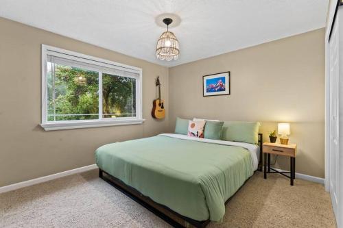 a bedroom with a bed and a window at Hot Tub Blackstone Fire Pit Ping Pong River in Nine Mile Falls