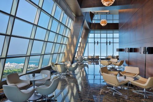 a conference room with chairs and tables and windows at Conrad Abu Dhabi Etihad Towers in Abu Dhabi