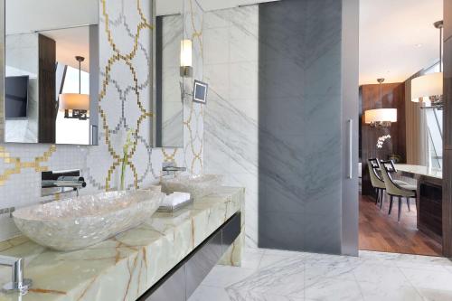 a bathroom with two sinks and a mirror at Conrad Abu Dhabi Etihad Towers in Abu Dhabi