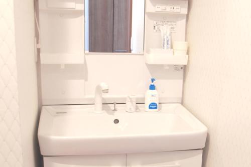 a bathroom with a white sink and a mirror at Chiba - House - Vacation STAY 87410 in Chiba