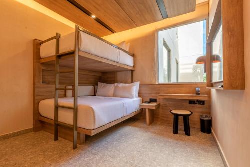 Una cama o camas en una habitación de Motto By Hilton Tulum