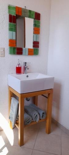 a bathroom with a white sink and a mirror at Casa con alberca privada y agradable jardín in Oaxtepec
