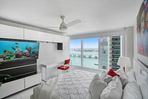 a living room with a fish tank and a tv at Seas The Day! Complete Panoramic Water Views in Miami