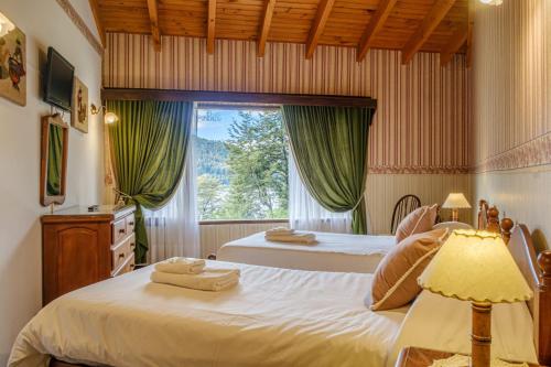 a bedroom with two beds and a window at Hosteria El Condado by Nordic in San Carlos de Bariloche