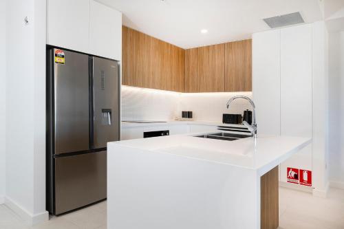 a kitchen with a refrigerator and a sink at Solaris 505 in Forster