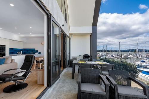 a living room with a view of a marina at Bay of Islands Apartment with Marina Views in Opua