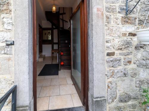 a door leading into a room with a stone wall at Riverside Loft in Esneux in Esneux