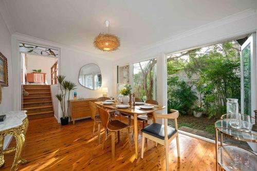 a dining room with a table and some chairs at Victorian Dream Terrace CBD in Sydney