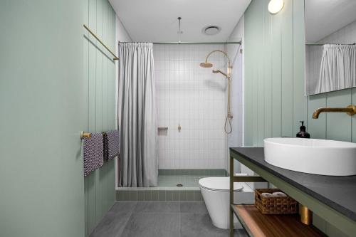 a bathroom with a sink and a toilet and a shower at Axbridge in Flinders