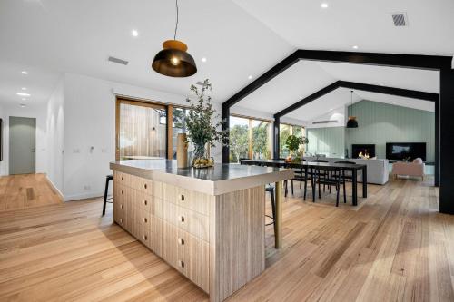 an open kitchen and dining room with a large island at Axbridge in Flinders